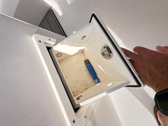  Yacht Photos Pics Open storage compartment on 2019 Jupiter 30 HFS boat with a blue lighter inside.