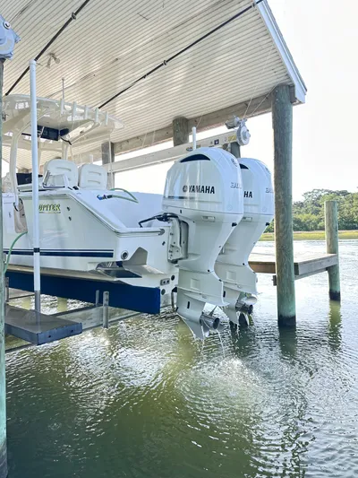  Yacht Photos Pics 2019 Jupiter 30 HFS boat with twin Yamaha engines docked under a covered structure.