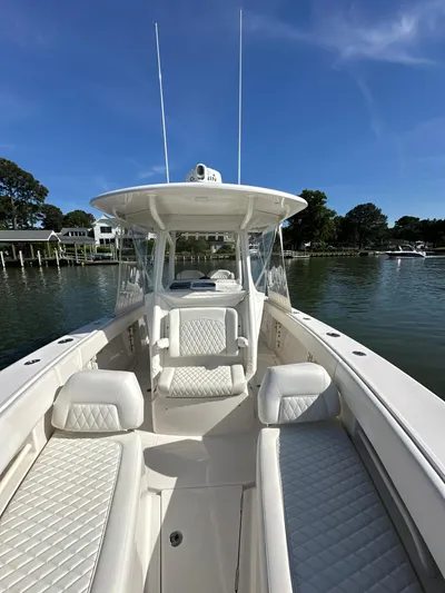  Yacht Photos Pics 2019 Jupiter 30 HFS boat on calm water, clear sky, luxurious seating.