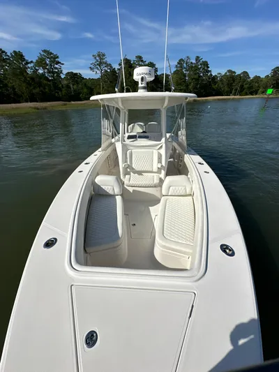  Yacht Photos Pics 2019 Jupiter 30 HFS boat on calm water with lush green shoreline.