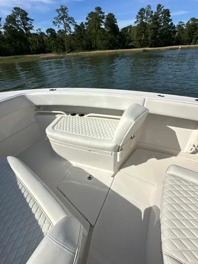  Yacht Photos Pics 2019 Jupiter 30 HFS boat interior with quilted seating, near a serene lake.