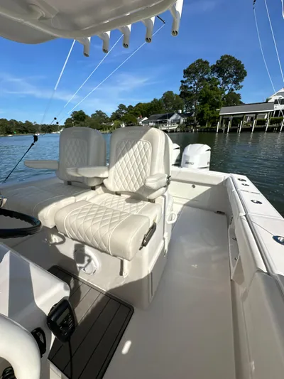  Yacht Photos Pics 2019 Jupiter 30 HFS boat interior with white seating, on a calm waterway.