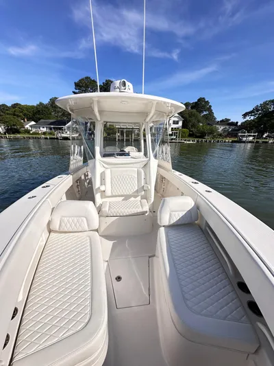  Yacht Photos Pics 2019 Jupiter 30 HFS boat with white seating, on calm water, under a clear blue sky.