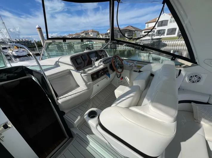 Happy Ours Yacht Photos Pics 2005 Formula 40 PC yacht cockpit with white seating and modern controls, docked at marina.