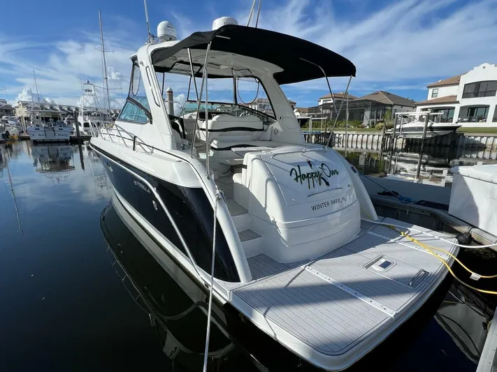 Happy Ours Yacht Photos Pics 2005 Formula 40 PC yacht docked at marina, featuring sleek design and spacious deck.
