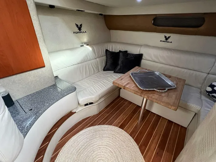 Happy Ours Yacht Photos Pics Luxurious interior of a 2005 Formula 40 PC yacht with elegant seating and wooden flooring.