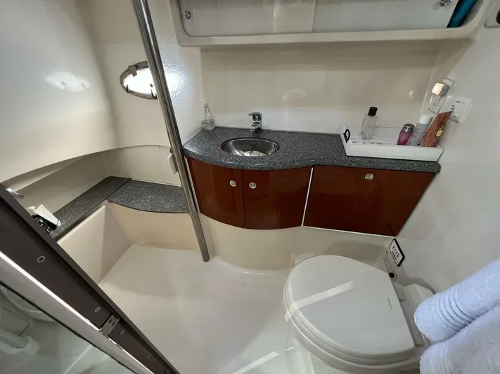 Happy Ours Yacht Photos Pics 2005 Formula 40 PC yacht bathroom with sink, toilet, and storage cabinets.