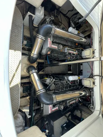 Happy Ours Yacht Photos Pics Engine compartment of a 2005 Formula 40 PC boat, showcasing dual engines and exhaust systems.