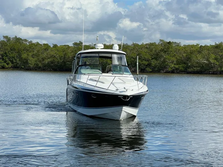 Happy Ours Yacht Photos Pics 2005 Formula 40 PC boat cruising on calm water with lush greenery background.