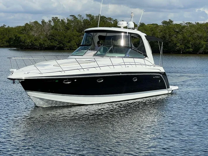 Happy Ours Yacht Photos Pics 2005 Formula 40 PC yacht cruising on calm water with lush greenery in the background.