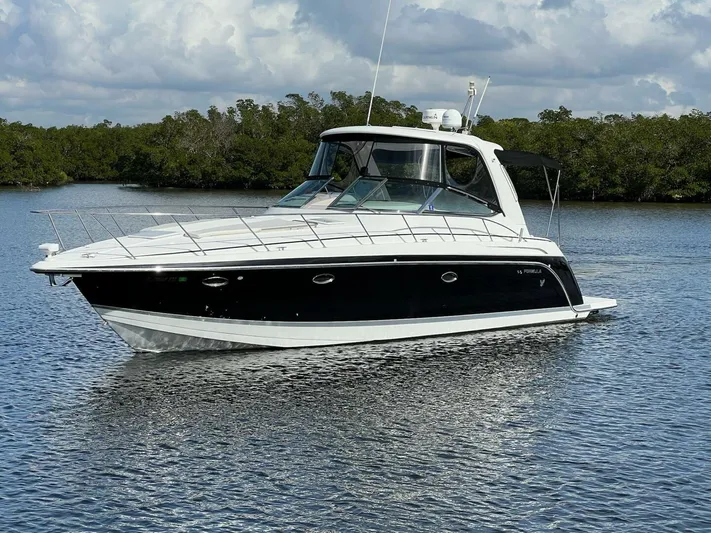 Happy Ours Yacht Photos Pics 2005 Formula 40 PC yacht on calm water with lush greenery background.