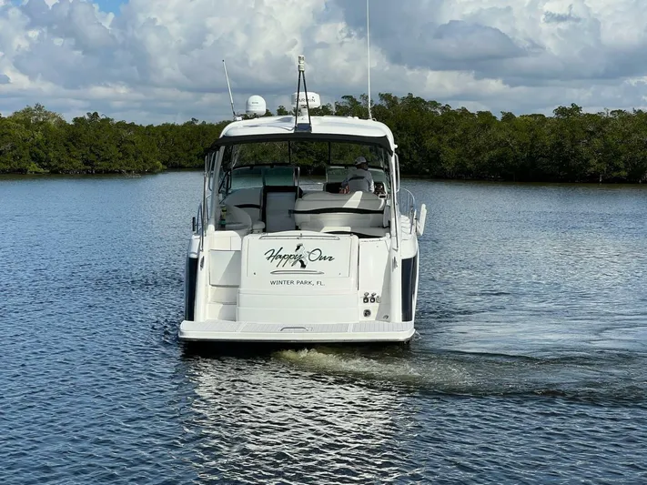 Happy Ours Yacht Photos Pics 2005 Formula 40 PC yacht cruising on calm water, surrounded by lush greenery.