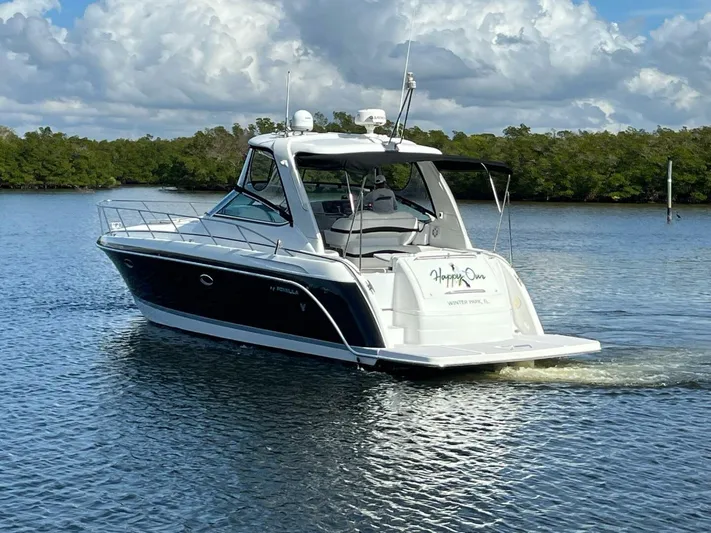 Happy Ours Yacht Photos Pics 2005 Formula 40 PC yacht cruising on calm water under a partly cloudy sky.