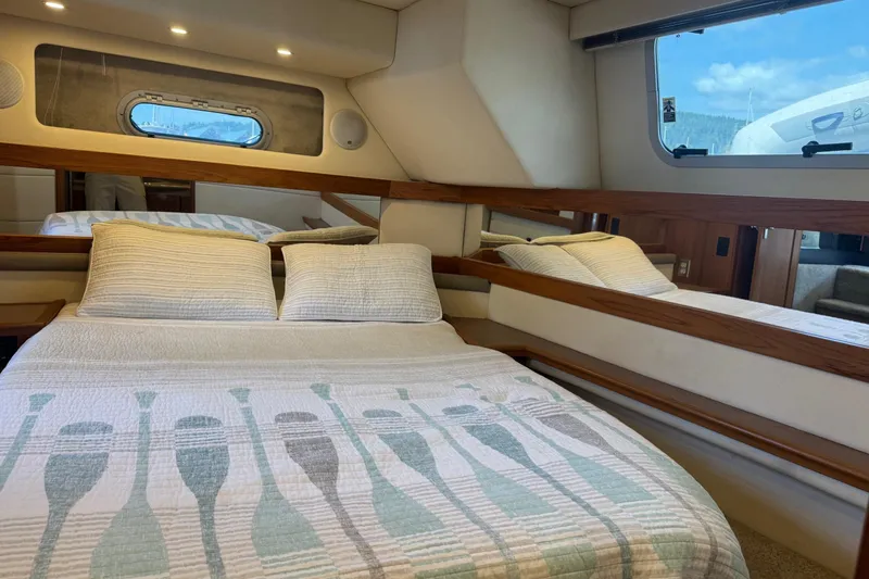 Lost Together Yacht Photos Pics Cozy bedroom in 1996 Bayliner 4087 Aft Cabin Motoryacht with nautical-themed bedding.