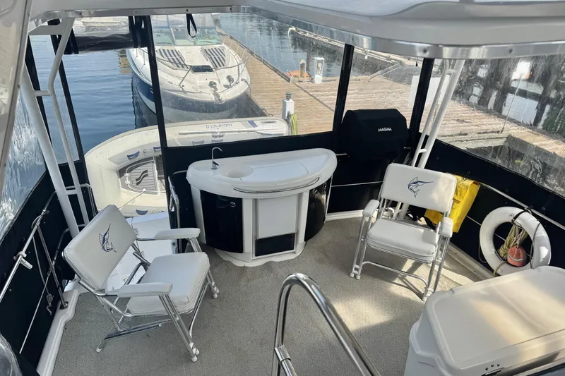 Lost Together Yacht Photos Pics 1996 Bayliner 4087 Aft Cabin Motoryacht interior with seating, sink, and marina view.
