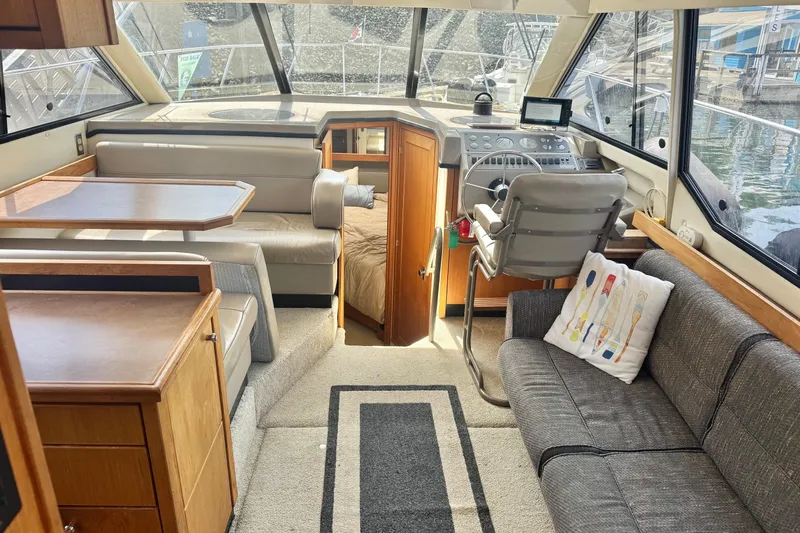 Lost Together Yacht Photos Pics 1996 Bayliner 4087 Aft Cabin Motoryacht interior with helm, seating, and dining area.