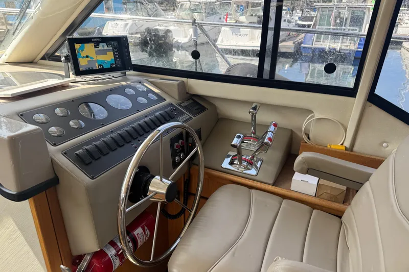 Lost Together Yacht Photos Pics 1996 Bayliner 4087 Aft Cabin Motoryacht helm with steering wheel and navigation system.