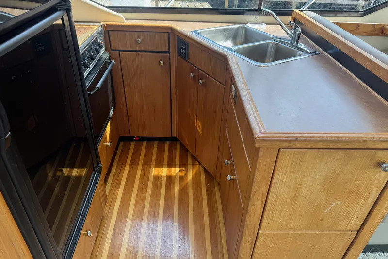 Lost Together Yacht Photos Pics 1996 Bayliner 4087 Aft Cabin Motoryacht kitchen with wood cabinets and dual sink.