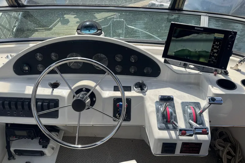 Lost Together Yacht Photos Pics 1996 Bayliner 4087 Aft Cabin Motoryacht helm with steering wheel and navigation equipment.