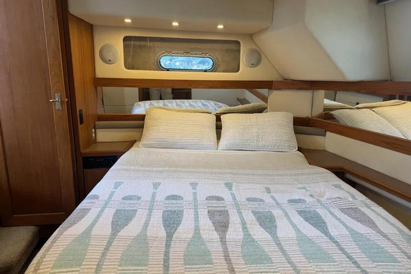 Lost Together Yacht Photos Pics Cozy bedroom in 1996 Bayliner 4087 Aft Cabin Motoryacht with nautical-themed bedding.