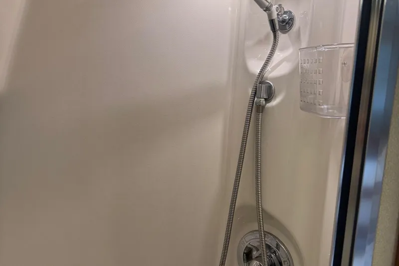 Lost Together Yacht Photos Pics Shower area in 1996 Bayliner 4087 Aft Cabin Motoryacht, featuring handheld showerhead.