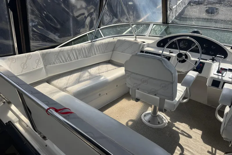 Lost Together Yacht Photos Pics 1996 Bayliner 4087 Aft Cabin Motoryacht helm with white seating and steering wheel.