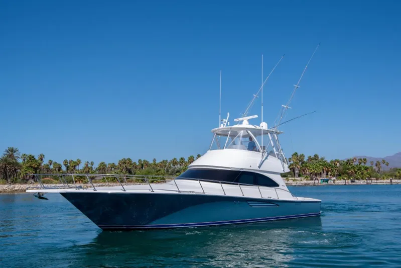Andiamo Yacht Photos Pics 2017 Viking 48 Convertible yacht cruising on a sunny day, surrounded by palm trees.