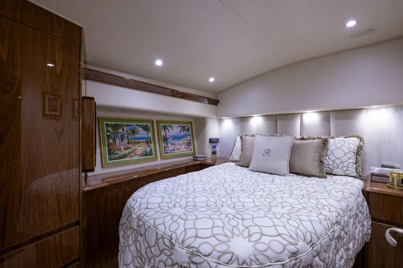 Andiamo Yacht Photos Pics Luxurious bedroom interior of 2017 Viking 48 Convertible yacht with elegant bedding and artwork.