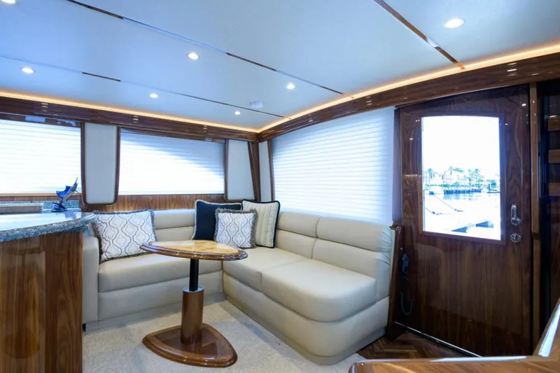 Andiamo Yacht Photos Pics Luxurious interior of 2017 Viking 48 Convertible yacht with plush seating and elegant wood finishes.