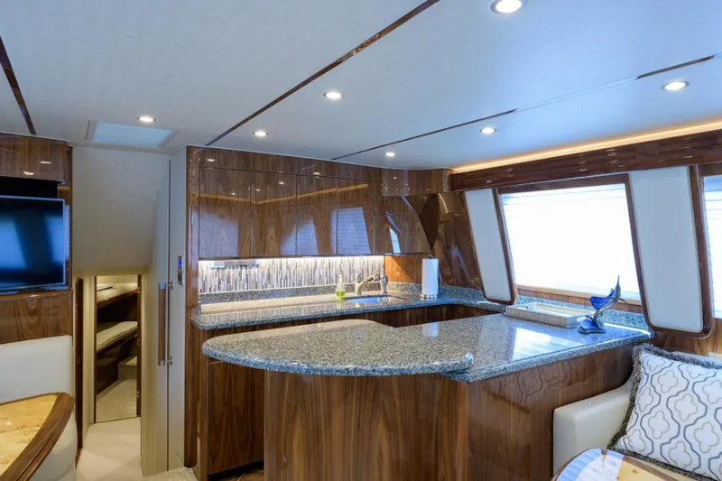 Andiamo Yacht Photos Pics Luxurious interior of 2017 Viking 48 Convertible yacht with modern kitchen and elegant wood finishes.