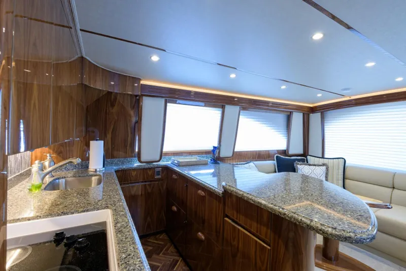 Andiamo Yacht Photos Pics Luxurious interior of 2017 Viking 48 Convertible yacht with modern kitchen and seating area.