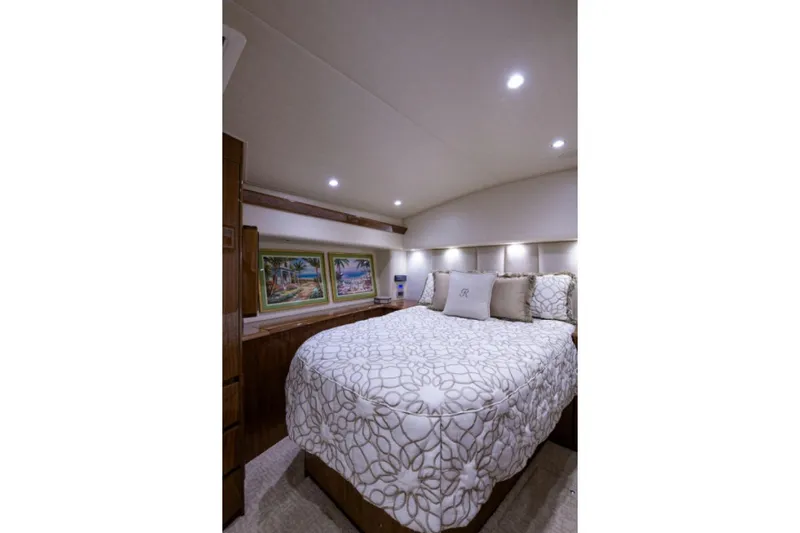 Andiamo Yacht Photos Pics Luxurious bedroom interior of 2017 Viking 48 Convertible yacht with elegant bedding and artwork.