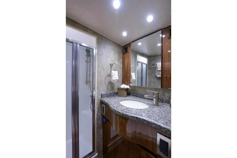 Andiamo Yacht Photos Pics Luxurious bathroom in 2017 Viking 48 Convertible yacht with granite countertop and modern fixtures.