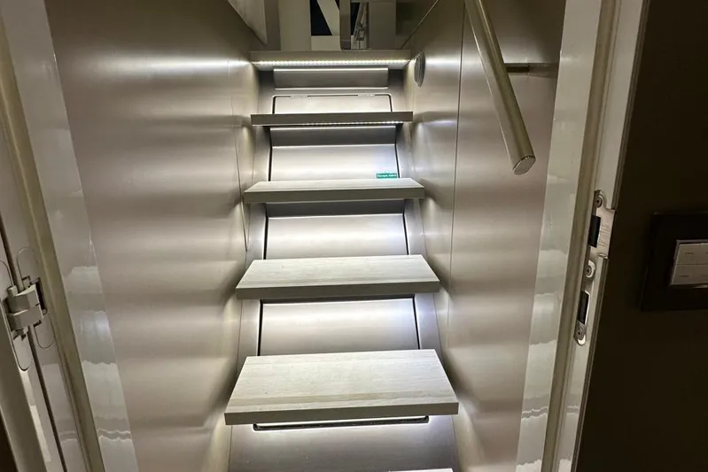Dolphin Yacht Photos Pics Staircase inside 2019 Sunreef 50 yacht, featuring modern design and ambient lighting.