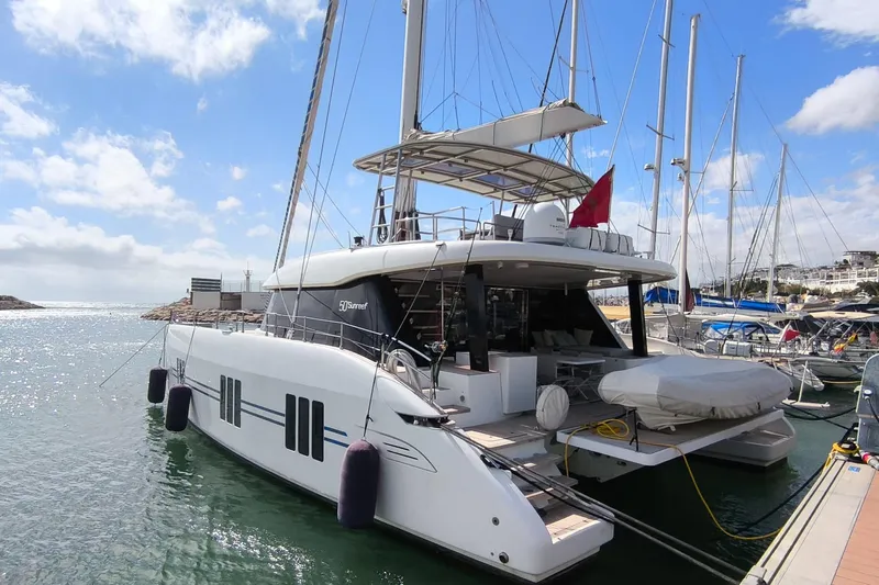 Dolphin Yacht Photos Pics Luxury 2019 Sunreef 50 catamaran docked at marina under clear blue sky.