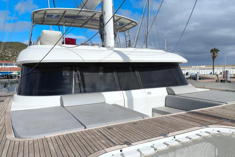 Dolphin Yacht Photos Pics 2019 Sunreef 50 catamaran with spacious deck and modern design in marina setting.