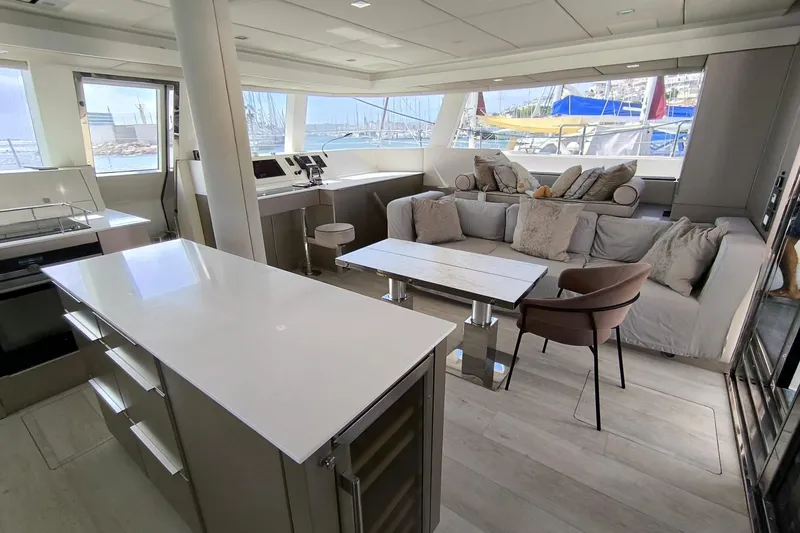 Dolphin Yacht Photos Pics Luxurious interior of 2019 Sunreef 50 yacht with modern kitchen and cozy seating area.