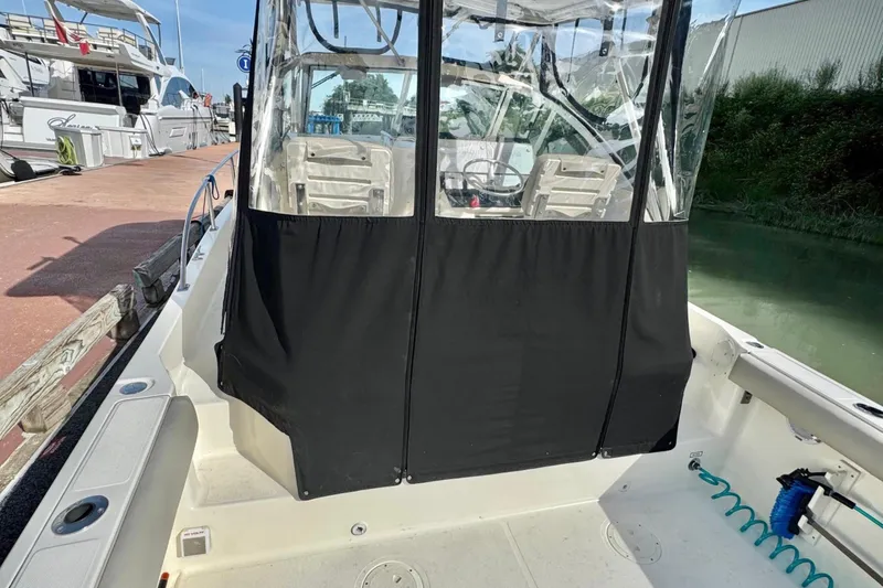  Yacht Photos Pics 2004 Pursuit 2870 Walkaround boat docked, featuring a covered cockpit area.