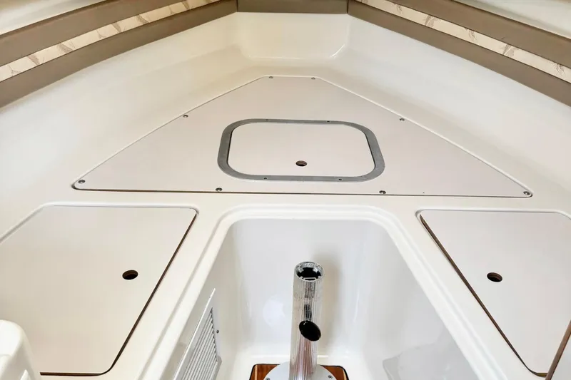  Yacht Photos Pics 2004 Pursuit 2870 Walkaround boat interior with storage compartments and clean design.