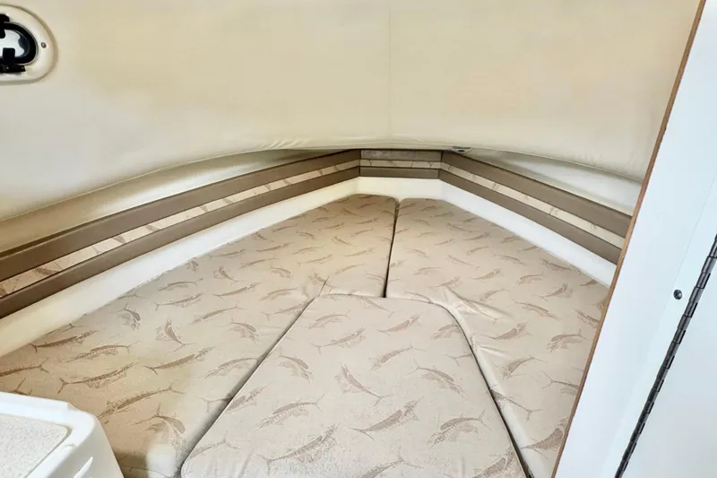  Yacht Photos Pics 2004 Pursuit 2870 Walkaround cabin interior with patterned cushions and beige walls.