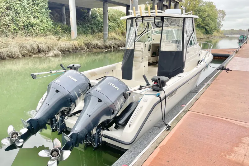  Yacht Photos Pics 2004 Pursuit 2870 Walkaround boat docked with dual outboard engines.