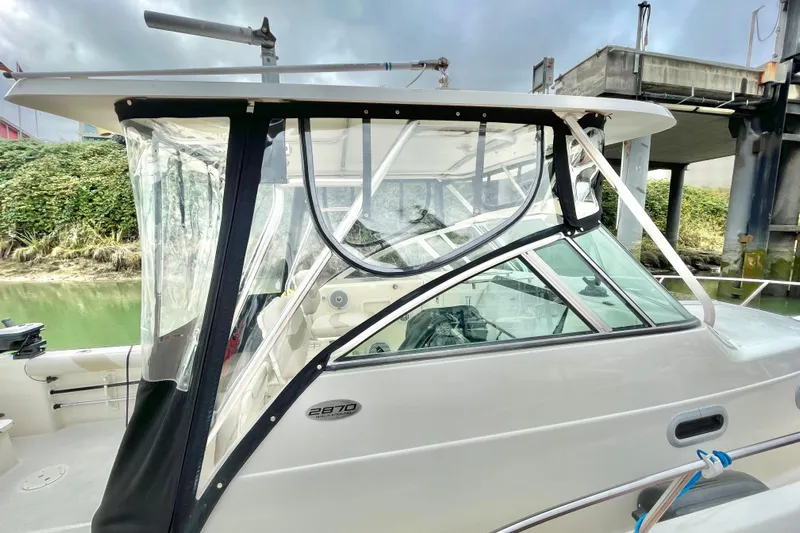  Yacht Photos Pics 2004 Pursuit 2870 Walkaround boat with clear enclosure and sleek design.