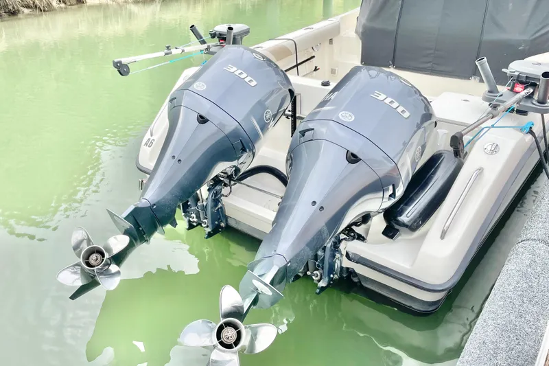  Yacht Photos Pics 2004 Pursuit 2870 Walkaround with dual 300 horsepower outboard engines in green water.