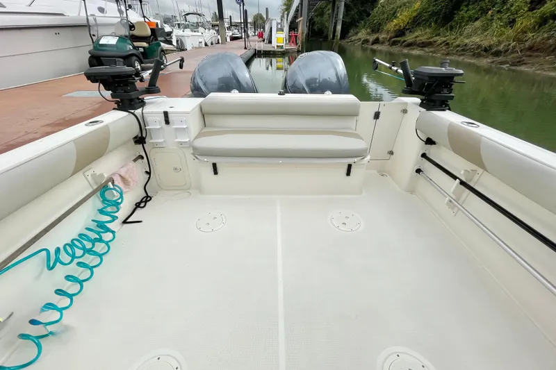 Yacht Photos Pics 2004 Pursuit 2870 Walkaround boat interior with fishing equipment and dual engines at dock.