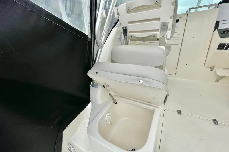  Yacht Photos Pics 2004 Pursuit 2870 Walkaround boat interior with storage compartment under seat.