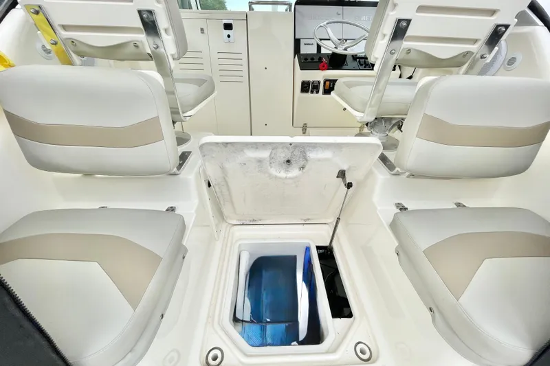  Yacht Photos Pics 2004 Pursuit 2870 Walkaround boat interior with seating and storage compartment.