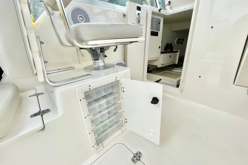  Yacht Photos Pics 2004 Pursuit 2870 Walkaround boat interior with storage compartments and seating.