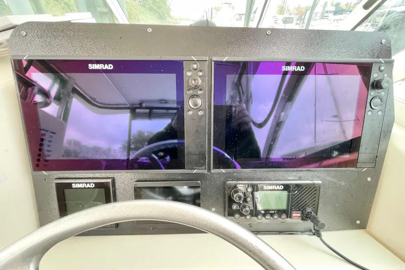  Yacht Photos Pics Dashboard of a 2004 Pursuit 2870 Walkaround boat with Simrad navigation displays.