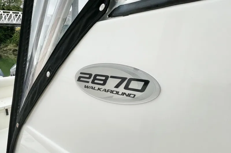  Yacht Photos Pics 2004 Pursuit 2870 Walkaround boat emblem on white surface.