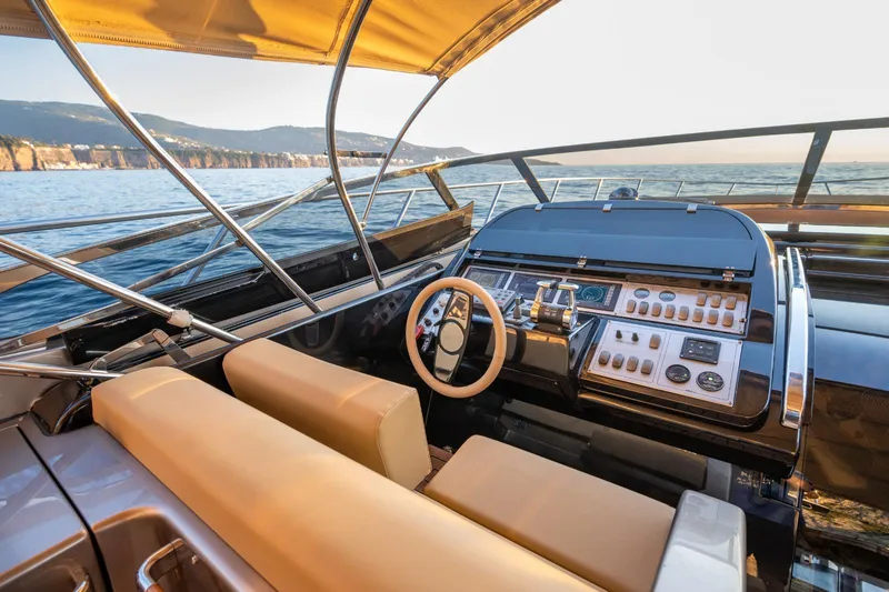  Yacht Photos Pics 2007 Riva Rivale 52 yacht cockpit with luxurious seating and control panel, overlooking the ocean.